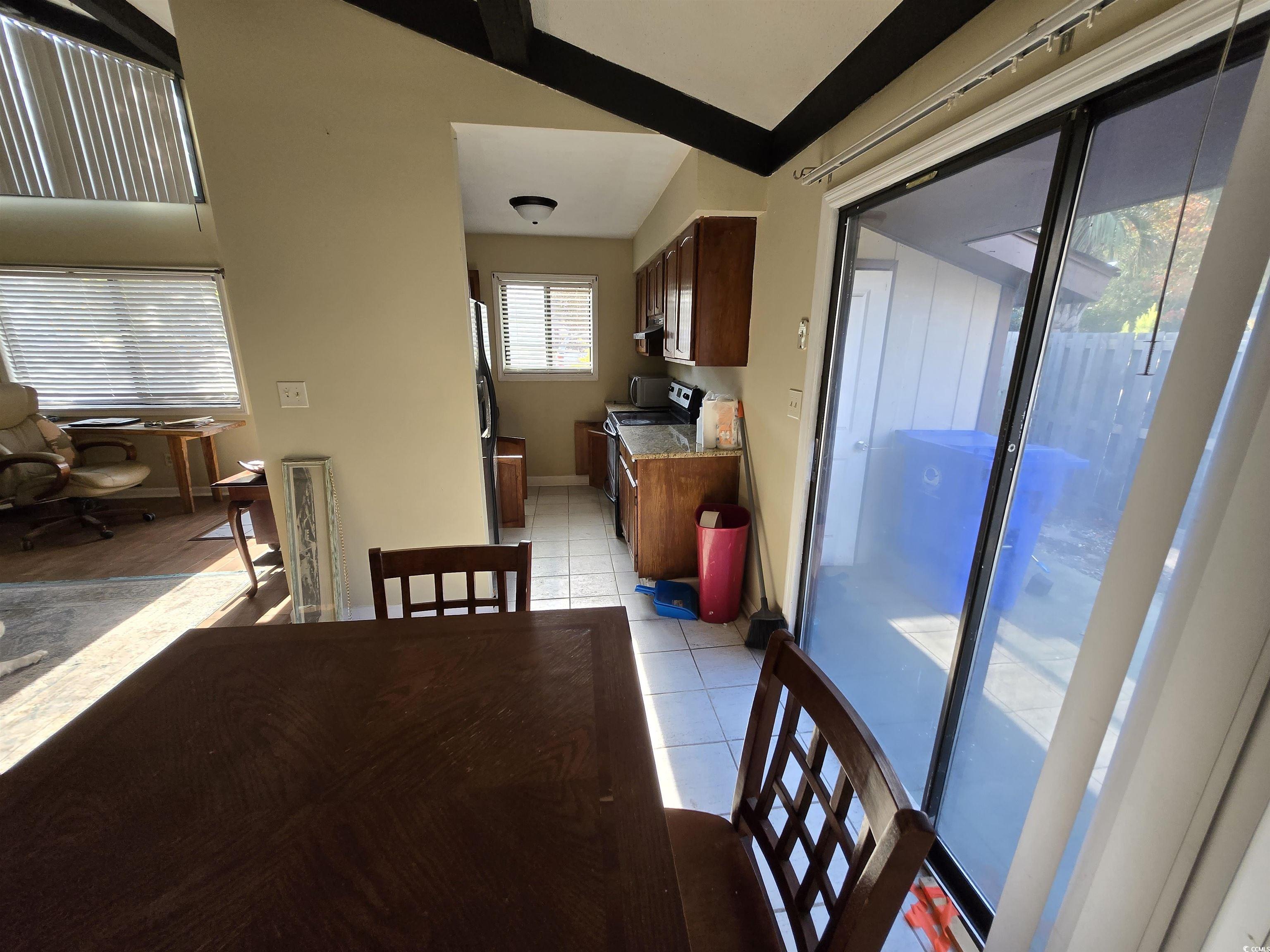 604 35th Avenue North, Unit A Myrtle Beach, SC 29577 - Photo 3 of 10 Dining area with light tile patterned floors and baseboards