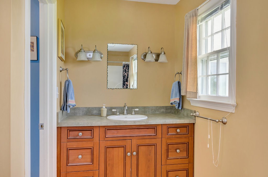 3354 Free Union Road Charlottesville, VA 22901 - Photo 18 of 45 a bathroom with a granite countertop sink and a mirror