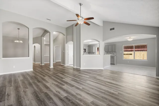a view of kitchen with windows and refrigerator