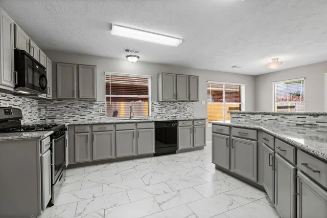 a kitchen with a sink and cabinets