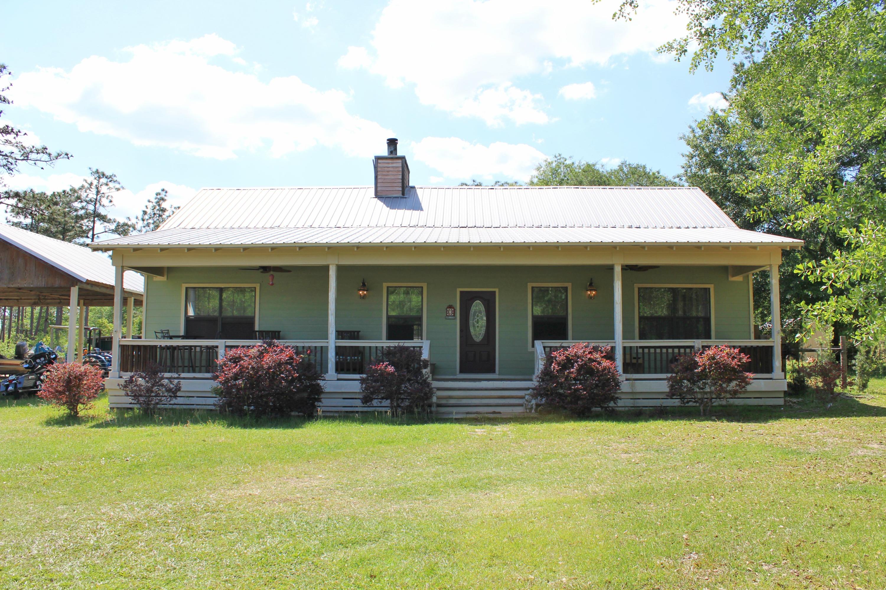 2913 King Lake Road DeFuniak Springs, FL 32433 - Photo 3 of 31 a front view of house with outdoor seating and barbeque oven