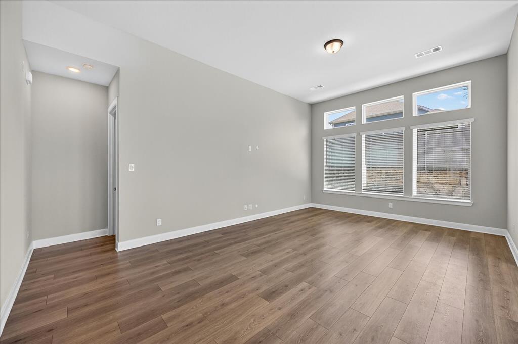2237 Pika Road Northlake, TX 76247 - Photo 6 of 37 Spacious room featuring wood-finish flooring, light gray walls, and white trim