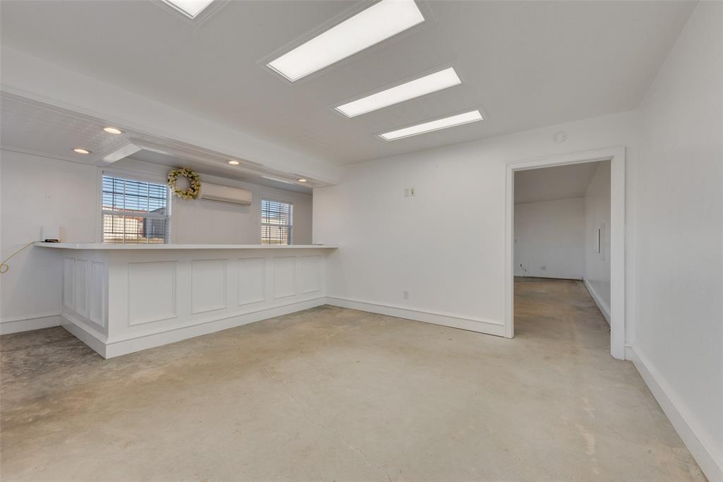 207 West Walnut Street Nocona, TX 76255 - Photo 13 of 22 an empty room with a empty space and windows