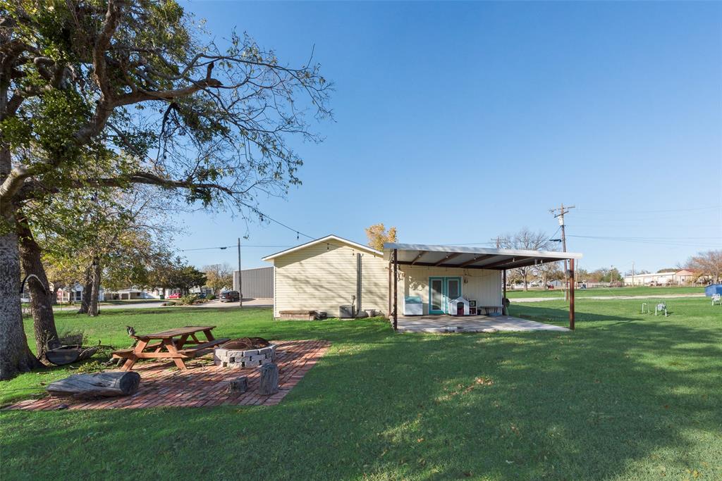 207 West Walnut Street Nocona, TX 76255 - Photo 15 of 22 a view of a house with a back yard