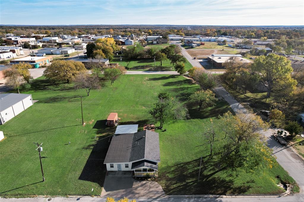 207 West Walnut Street Nocona, TX 76255 - Photo 16 of 22 an aerial view of a house with a yard
