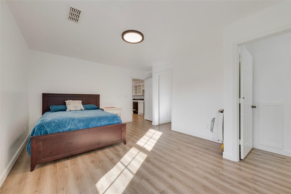 207 West Walnut Street Nocona, TX 76255 - Photo 7 of 22 a bedroom with a bed and wooden floor