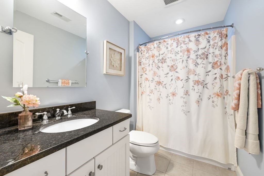 192 Boston Post Road, Unit 8 Sudbury, MA 01776 - Photo 18 of 27 a bathroom with a granite countertop sink and a mirror