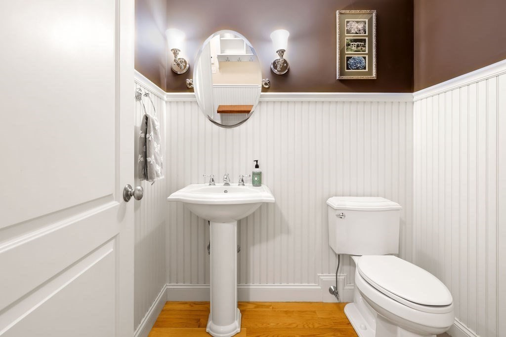 192 Boston Post Road, Unit 8 Sudbury, MA 01776 - Photo 25 of 27 a bathroom with a toilet sink and mirror