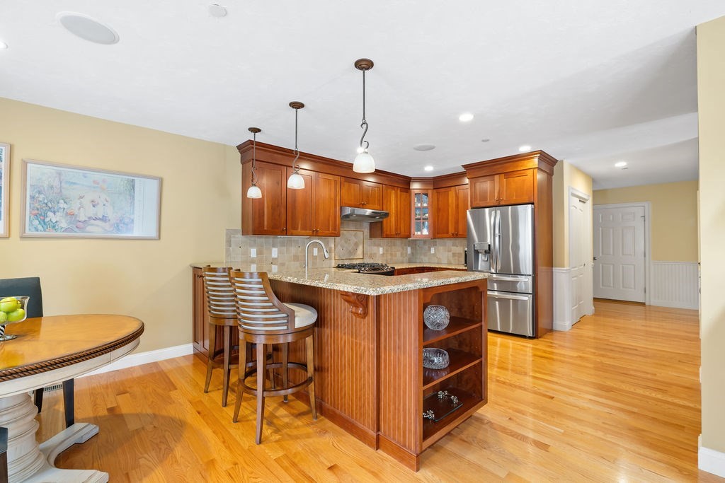 192 Boston Post Road, Unit 8 Sudbury, MA 01776 - Photo 6 of 27 a kitchen with stainless steel appliances granite countertop a stove a sink a refrigerator and chairs
