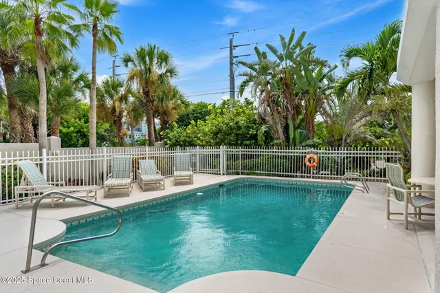 swimming pool view with a garden space