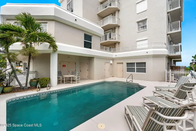 a front view of a house with garden and patio