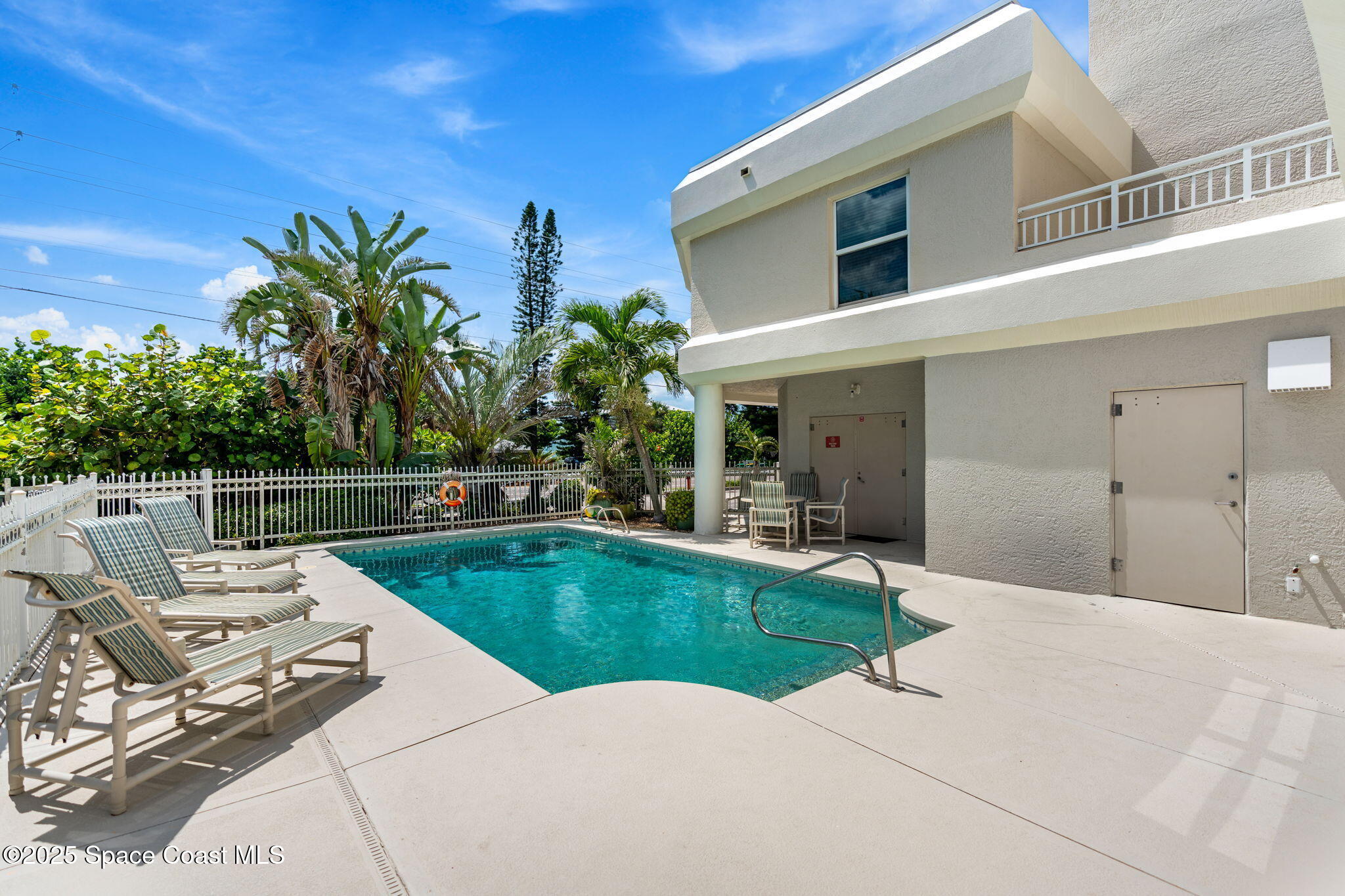 1155 South Atlantic Avenue, Unit 203 Cocoa Beach, FL 32931 - Photo 14 of 41 a view of a house with swimming pool and sitting area