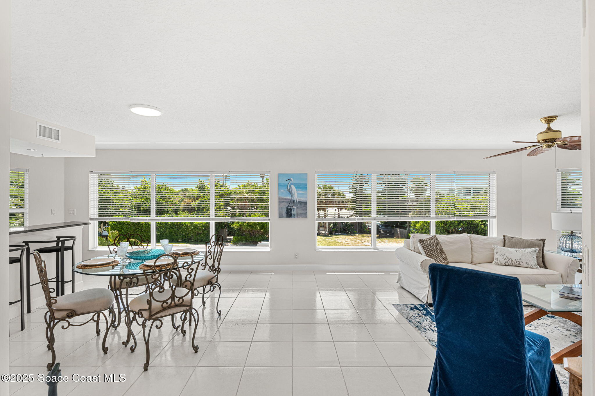 1155 South Atlantic Avenue, Unit 203 Cocoa Beach, FL 32931 - Photo 15 of 41 a living room with furniture and large windows