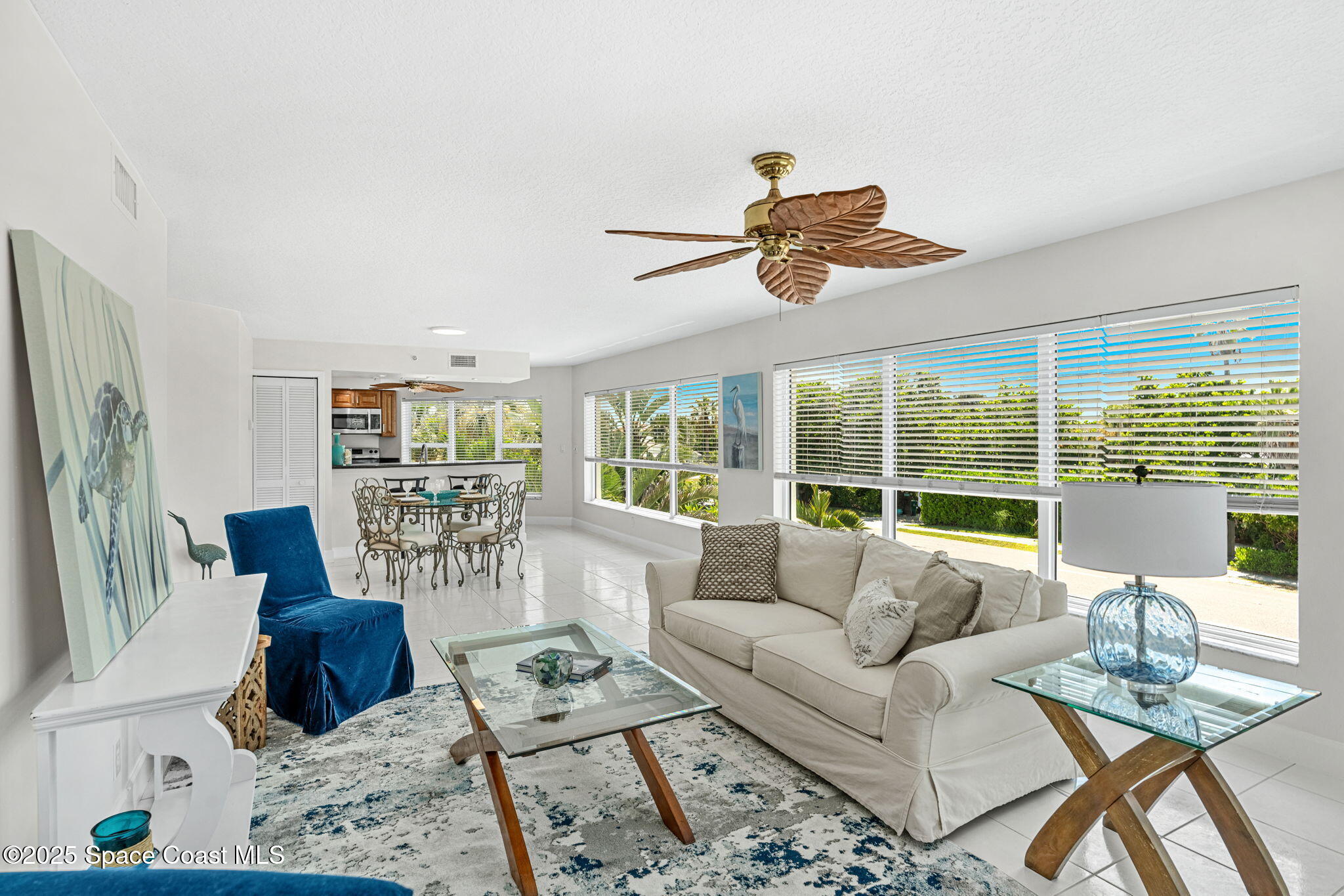 1155 South Atlantic Avenue, Unit 203 Cocoa Beach, FL 32931 - Photo 16 of 41 a living room with furniture ceiling fan and a large window