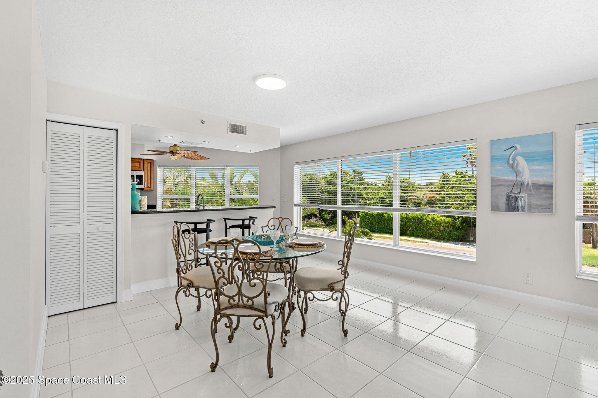 1155 South Atlantic Avenue, Unit 203 Cocoa Beach, FL 32931 - Photo 21 of 41 a dining room with furniture and window