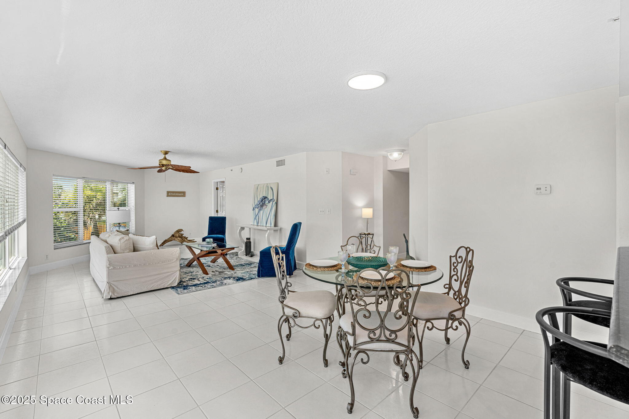 1155 South Atlantic Avenue, Unit 203 Cocoa Beach, FL 32931 - Photo 22 of 41 a living room with furniture and a large window