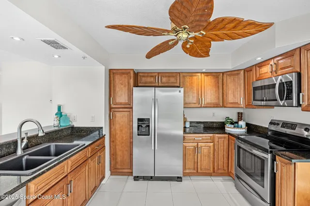 a kitchen that has stainless steel appliances a stove a sink and a microwave