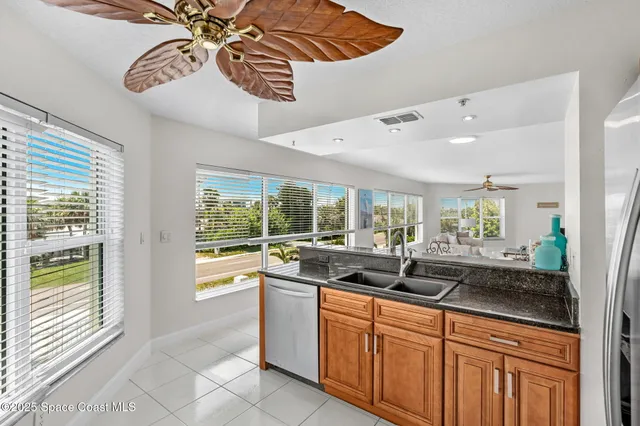 a kitchen with stainless steel appliances granite countertop a sink and a white cabinets