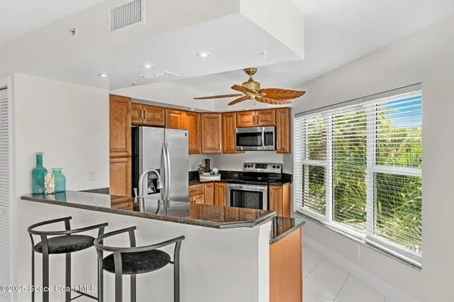 a kitchen with stainless steel appliances granite countertop a stove and a refrigerator
