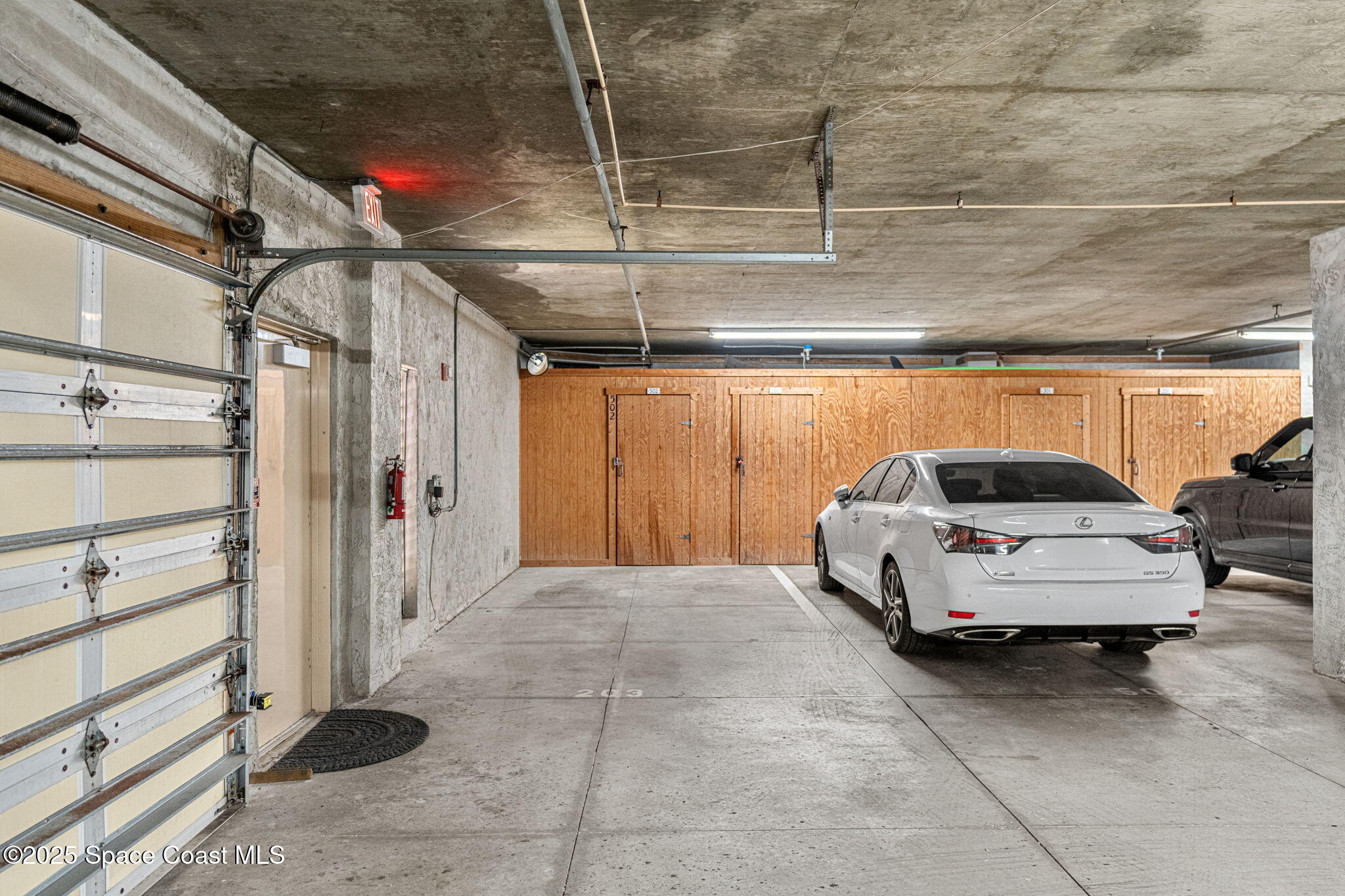 1155 South Atlantic Avenue, Unit 203 Cocoa Beach, FL 32931 - Photo 40 of 41 a car parked in garage