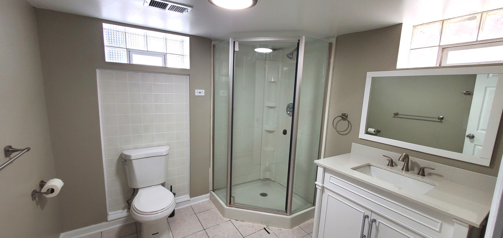 1241 Howard Avenue Berkeley, IL 60163 - Photo 13 of 14 a bathroom with a granite countertop toilet sink shower and mirror