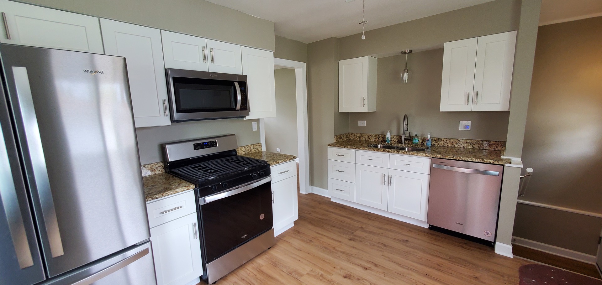 1241 Howard Avenue Berkeley, IL 60163 - Photo 9 of 14 a kitchen with white cabinets and stainless steel appliances