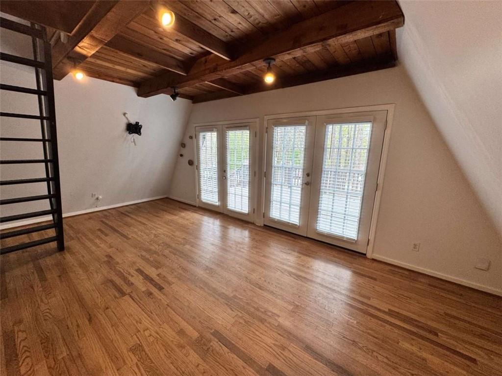 2475 Hawk Creek Trail Cumming, GA 30041 - Photo 3 of 24 a view of an empty room with wooden floor and a window