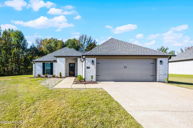 a front view of a house with yard patio and balcony