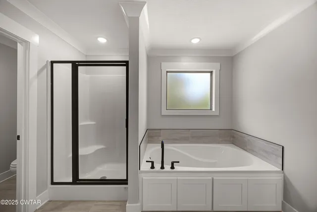 a bathroom with a double vanity sink double mirror and bathtub