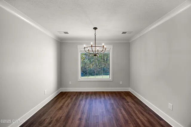 a kitchen with a sink stove and wooden floor