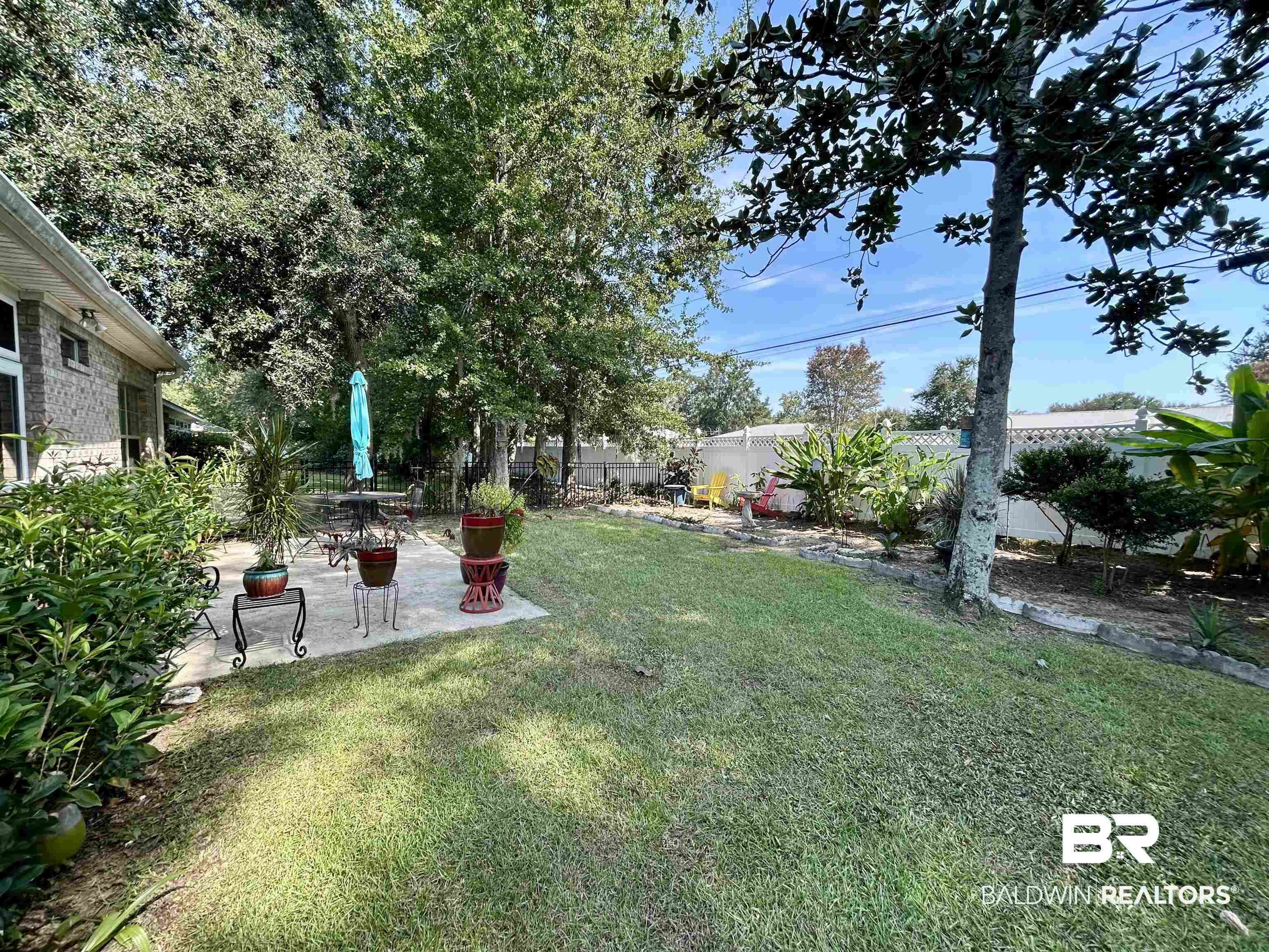 177 Mark Twain Loop Foley, AL 36535 - Photo 33 of 47 Fenced backyard featuring a patio