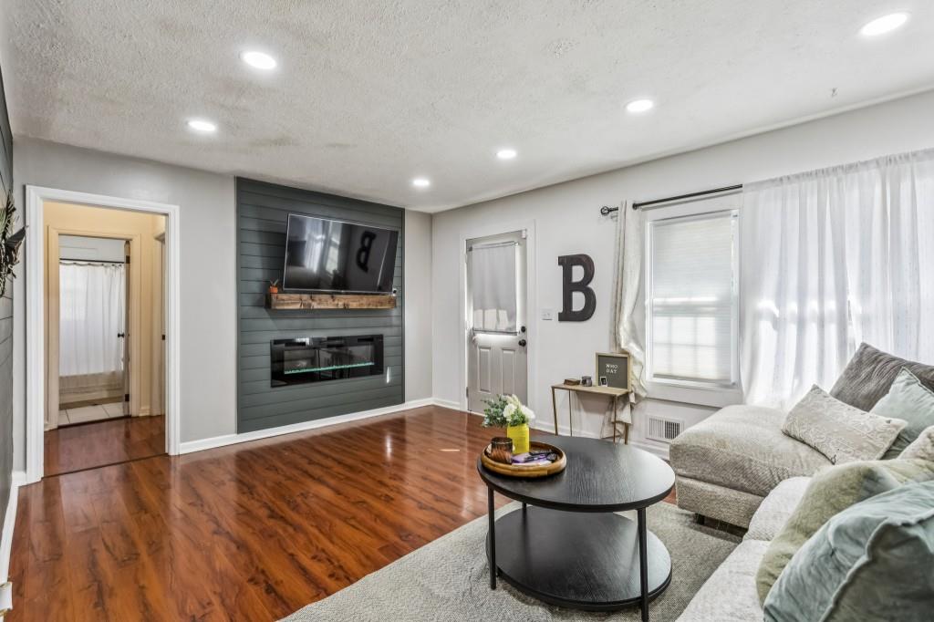 5430 Carol Circle Southwest Mableton, GA 30126 - Photo 11 of 32 a living room with fireplace furniture and a flat screen tv