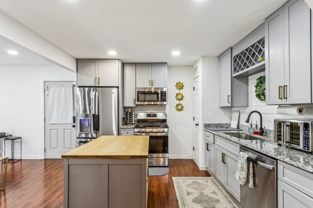 5430 Carol Circle Southwest Mableton, GA 30126 - Photo 14 of 32 a kitchen with refrigerator cabinets and wooden floor