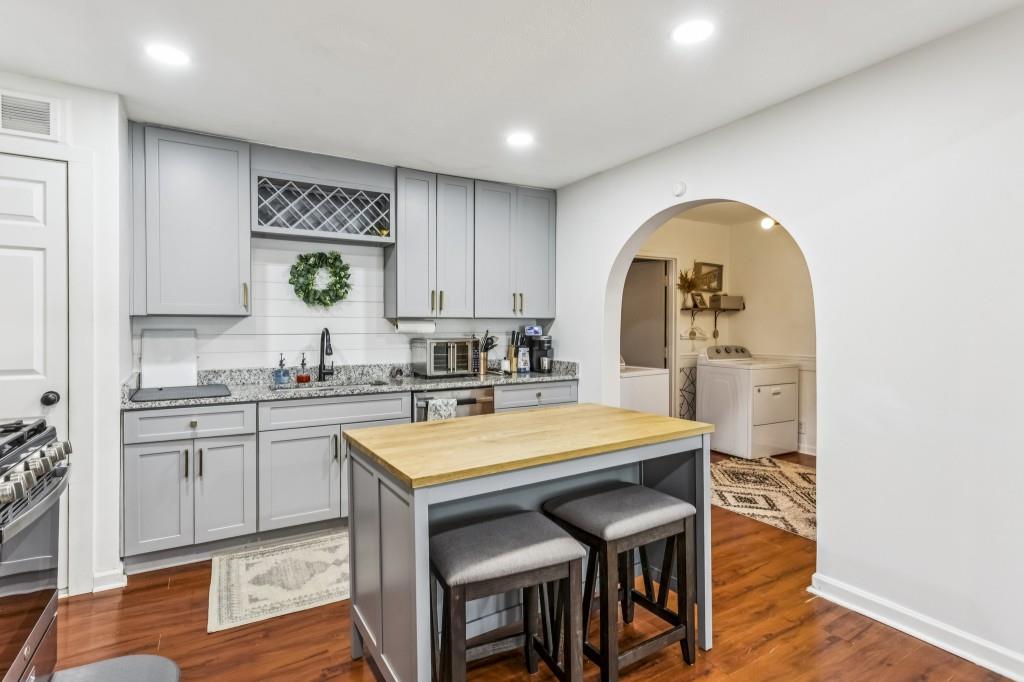 5430 Carol Circle Southwest Mableton, GA 30126 - Photo 15 of 32 a kitchen with a table chairs sink and cabinets