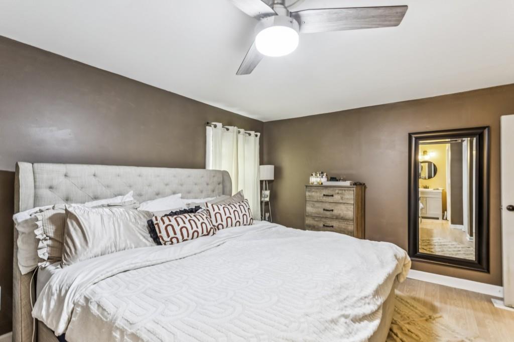 5430 Carol Circle Southwest Mableton, GA 30126 - Photo 17 of 32 a bedroom with a large bed and a chandelier