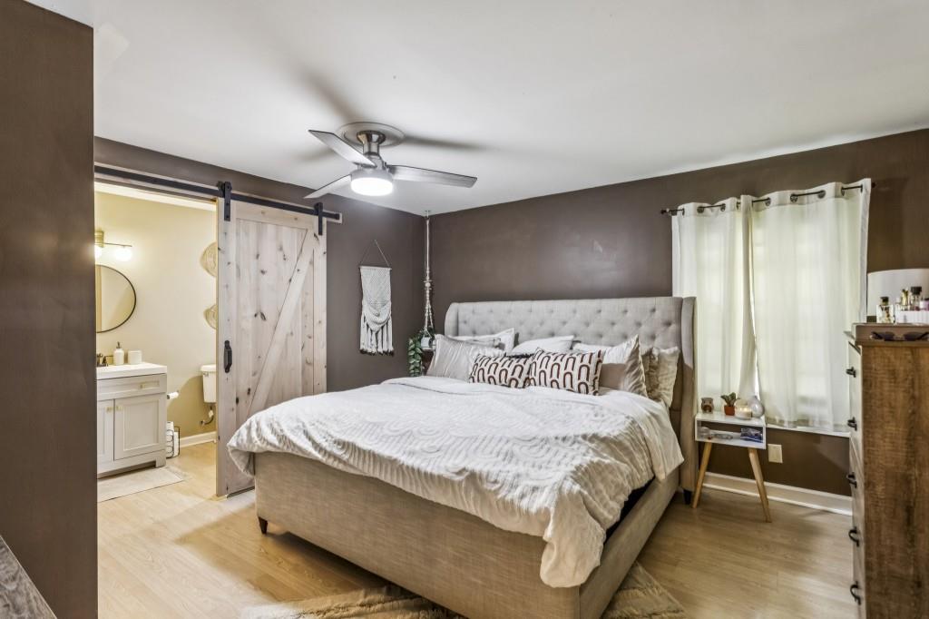 5430 Carol Circle Southwest Mableton, GA 30126 - Photo 4 of 32 a bedroom with a bed mirror and a window