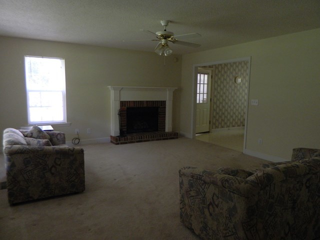 1625 Nowell Road West Macon, GA 31220 - Photo 9 of 21 a living room with furniture and a fireplace