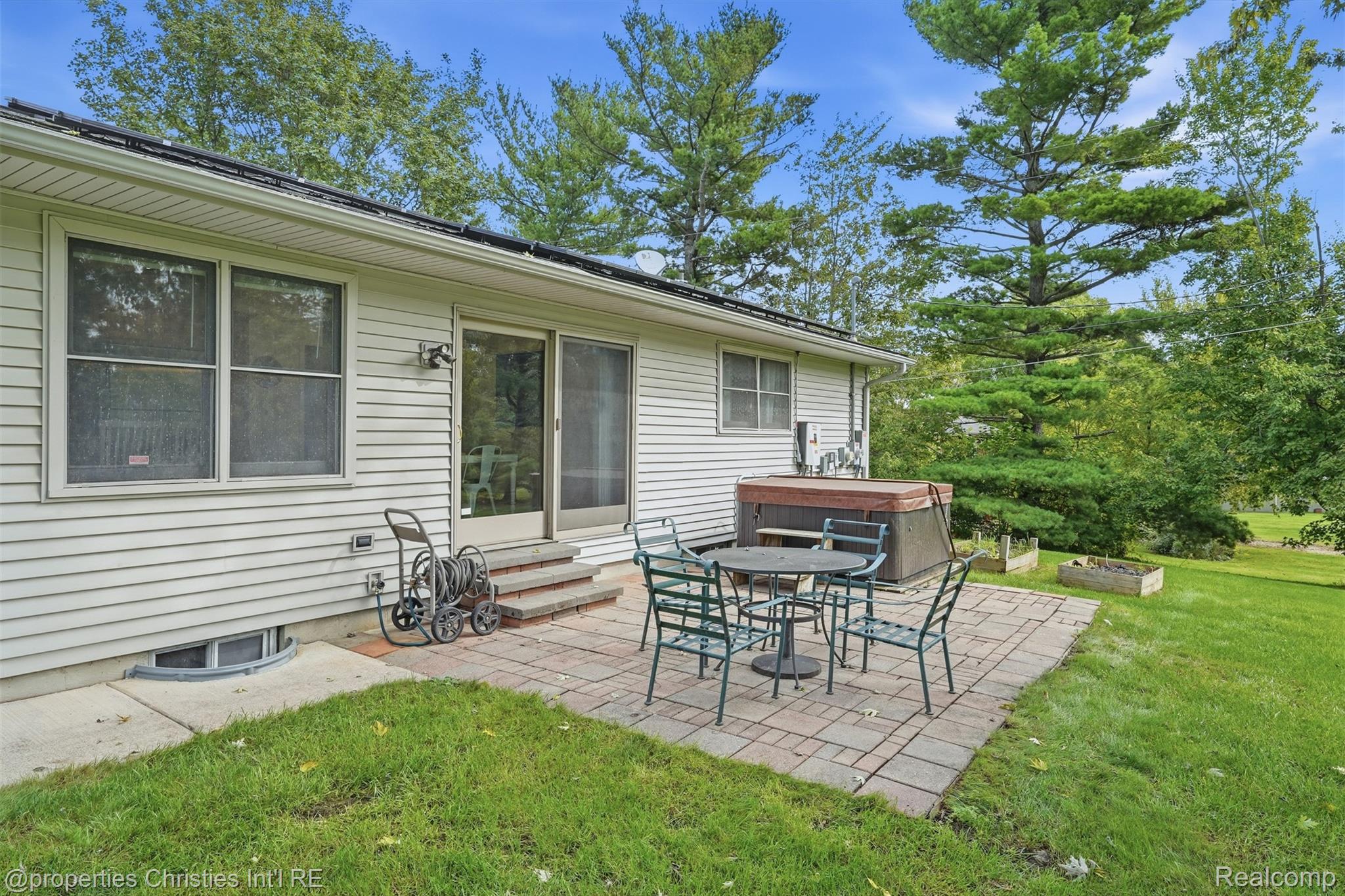 4030 Textile Road Ypsilanti, MI 48197 - Photo 39 of 58 Patio featuring paver stones, sliding glass door access, and a built-in spa