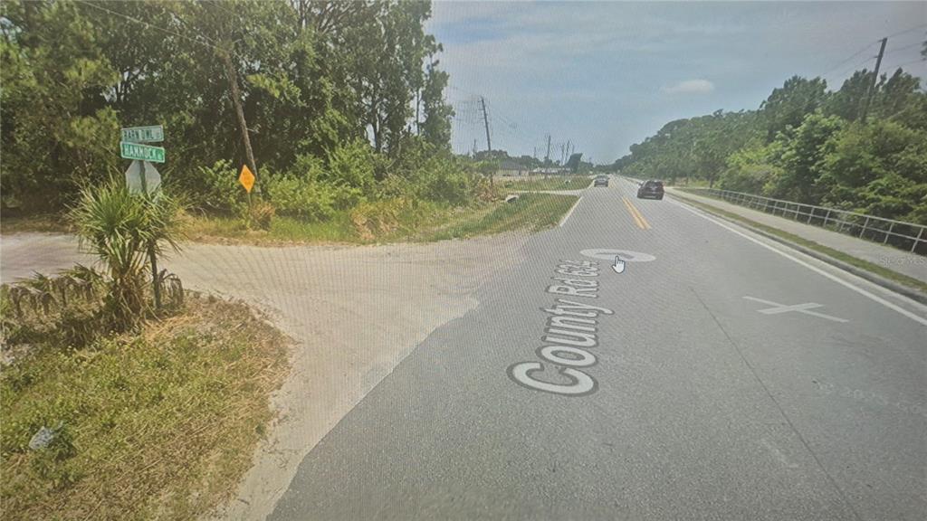 2630 Hammock Road Sebring, FL 33870 - Photo 5 of 8 a view of a road with a yard