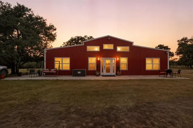 a view of a house with backyard porch and sitting area