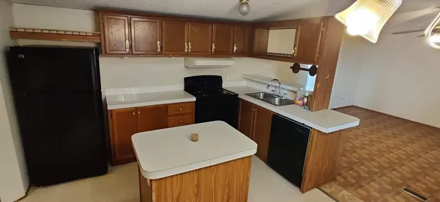 a kitchen with a sink a stove and refrigerator
