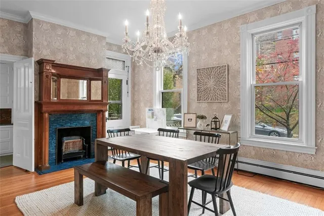a kitchen with kitchen island a dining table chairs sink and cabinets