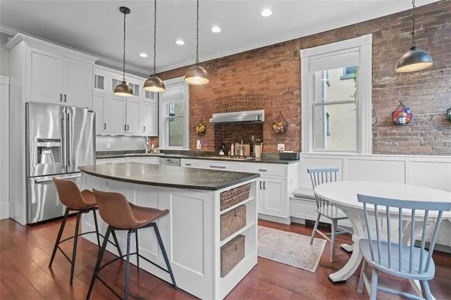 a kitchen with stainless steel appliances granite countertop sink stove and wooden cabinets