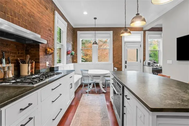 a kitchen with a table chairs sink and cabinets