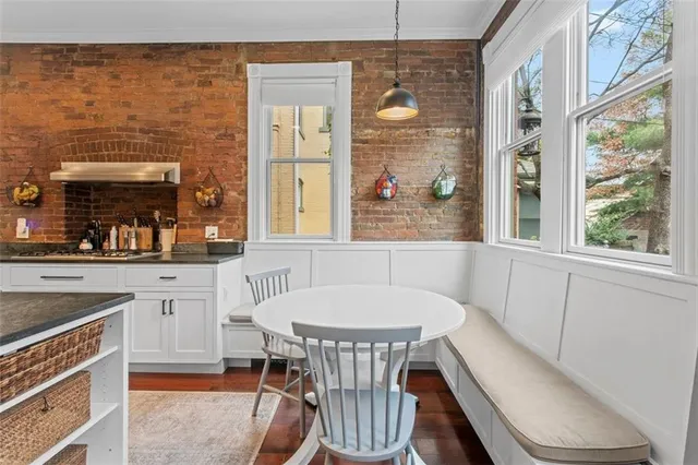 a kitchen with a sink cabinets and wooden floor