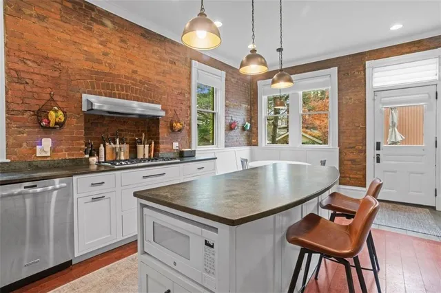 a kitchen with stainless steel appliances granite countertop a stove and a sink