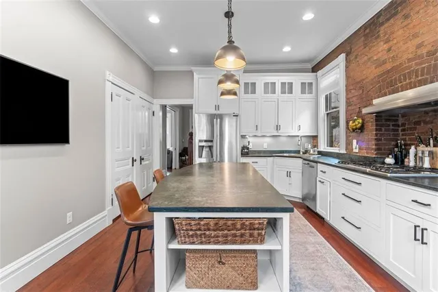 a view of a hallway with wooden floor and entryway