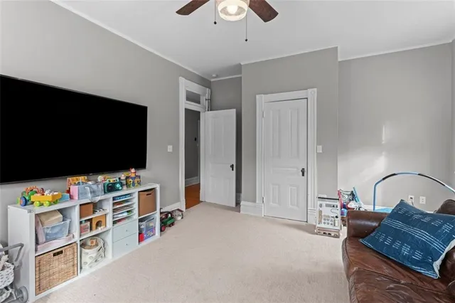 a spacious bedroom with a bed and a flat screen tv