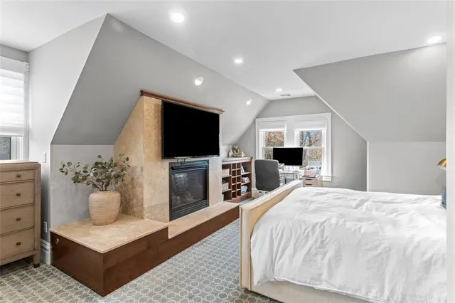 a bed room with a bed and a chair