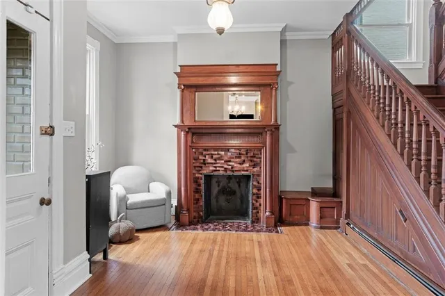 a living room with furniture a fireplace and a flat screen tv